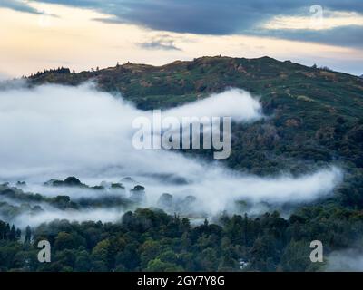 Morning mist below Black Fell from Todd Crag at dawn, Lake District, UK. Stock Photo