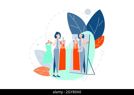 Choice, fashion, shopping concept. Fashionable woman is standing looking in mirror at her reflection. Girl does shopping, choose between dresses on da Stock Photo