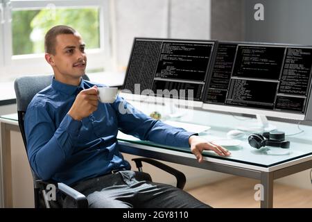Computer Programmer Writing Program Code On Computer In Office Stock Photo