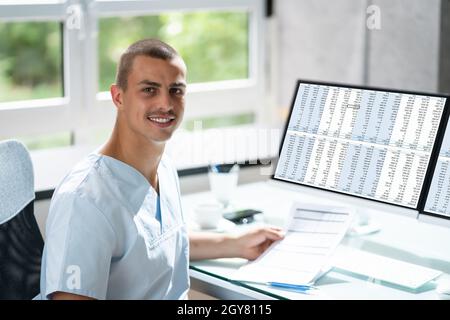Account Manager In Office Coding Medical Bill Stock Photo