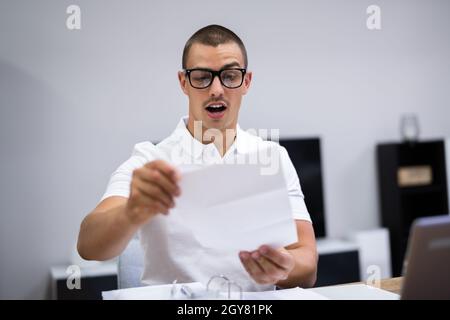 Happy Man Reading Exam Letter With Exam Results Stock Photo