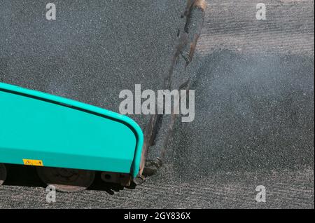 paving machine laying fresh tarmac Stock Photo