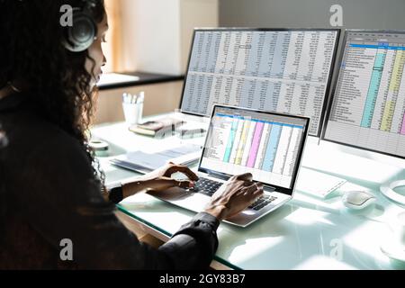 Data Analyst African Woman Using Spreadsheet On Computer Stock Photo
