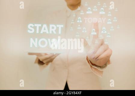 Text sign showing Start Now, Word Written on do not hesitate get working or doing stuff right away Lady Holding Tablet Pressing On Virtual Button Show Stock Photo