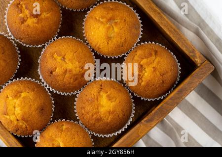 Biscuit muffins close-up. Sweet pastries. Party treat. Dessert on white table - homemade muffins. Portioned cupcakes. Simple muffin. Top view. Stock Photo