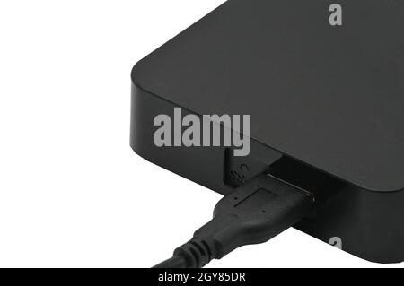 Portable hard drive for backing up various files on an isolated white background Stock Photo