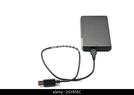 Portable hard drive for backing up various files on an isolated white background Stock Photo