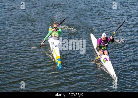 PLASENCIA, SPAIN - Apr 24, 2021: Plasencia, Spain - April 24, 2021: Two young men practices canoeing riding in his canoe navigating the Jerte river Stock Photo