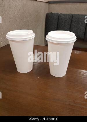 Side view of empty disposable takeaway coffee cup on a table Stock Photo