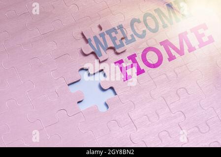 Conceptual caption Welcome Home, Word Written on Expression Greetings New Owners Domicile Doormat Entry Building An Unfinished White Jigsaw Pattern Pu Stock Photo