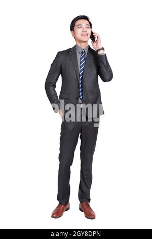 Young handsome businessman standing and talking on the phone. Stock Photo