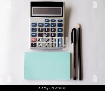 Blank Open Spiral Notebook With A Calculator And A Pen On Table. Stock Photo