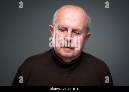 Senior man lonely at home, anxious/afraid to go out - self isolation/ quarantine due to COVID-19/ Coronavirus social distancing/prevention concept Stock Photo
