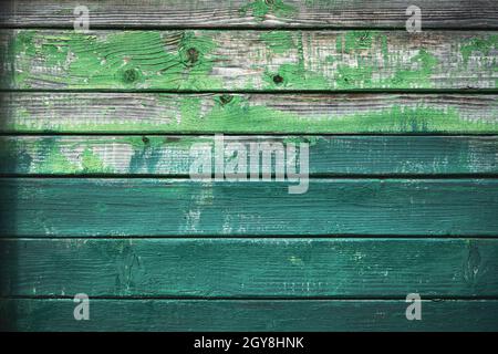 Old wooden grunge board painted in different shades of green color. Natural texture. Can be used like nature background Stock Photo