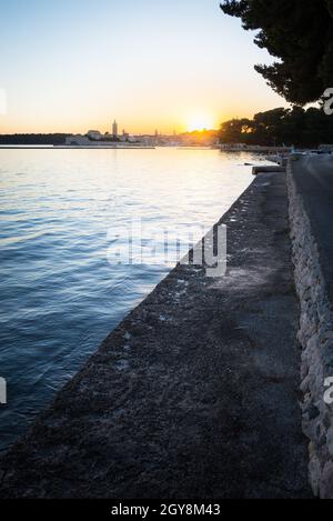 Rab sunset on beach mole at the bay of banjol in croatia Stock Photo