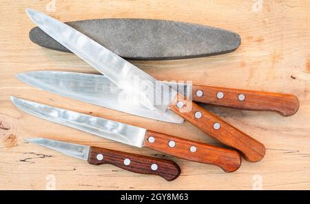 kitchen knife blade on grindstone Stock Photo - Alamy