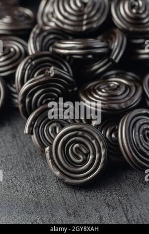 Spiral from liquorice candy on black table. Stock Photo
