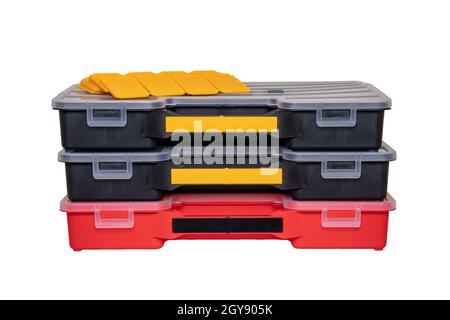 Equipment of craftsman. Three professional plastic storage boxes for screws, bolts, dowels and some other components isolated on a white background. H Stock Photo