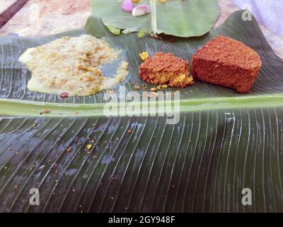 Daal Baati Churma is a popular Healthy food from Rajasthan, India. Served antique Brass plate and bowl over moody background. Stock Photo