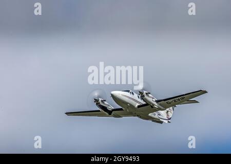 A Beech B200 Super King Air, G-ZVIP, taking off from Bristol Lulsgate Airport, England. Stock Photo