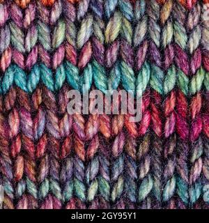 textile square background - pied hand-knitted woolen cloth close up Stock Photo