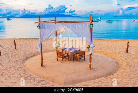 Romantic private dinner on honeymoon on the Bo Phut beach with Koh Phangan view on Koh Samui in Thailand. Stock Photo