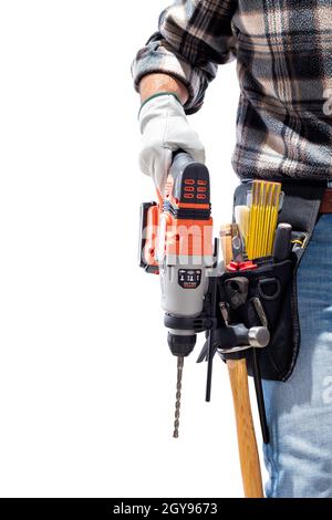 Carpenter worker at work holding rechargeable hammer drill, isolated on white background. Construction industry. Carpentry. Stock Photo