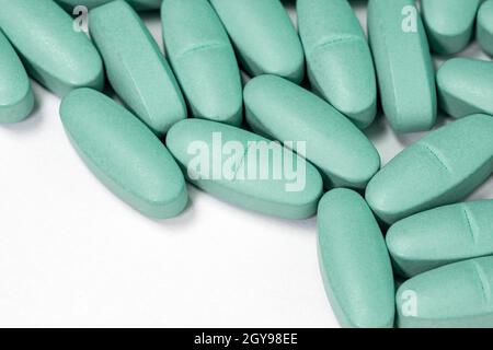 Medical pills spilled on white background, copy-space Stock Photo