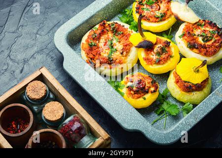 Squash stuffed with couscous and mushrooms. Baked patisson with shakshuka.Patty pan squash Stock Photo
