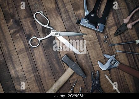 Different old tools on vintage wooden background. Flat lay. Stock Photo