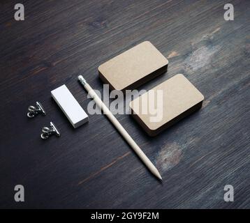 Blank kraft stationery set. Blank vintage business cards, pencil and eraser on wood table background. Stock Photo
