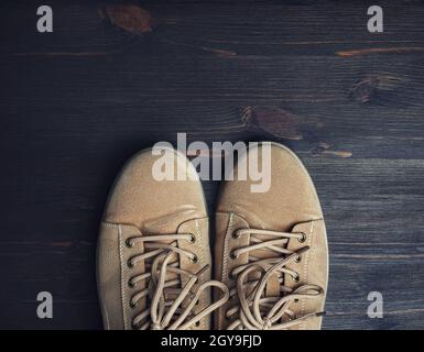 Boots on wooden floor background. Top view. Flat lay. Stock Photo