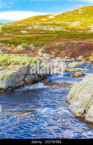 Beautiful Storebottane river by the vavatn lake with snow in the summer landscape in Hemsedal Norway. Stock Photo