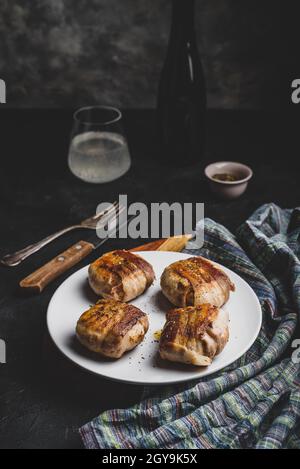 Bacon-wrapped button mushrooms stuffed with grated cheddar cheese and spices Stock Photo
