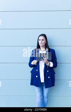 Beautiful Caucasian businesswoman with tablet working in the str Stock Photo