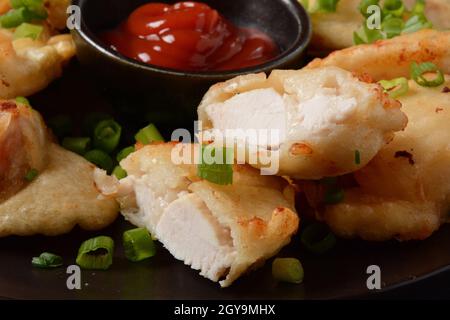 Golden crispy fried chicken fillet. Fried chicken pieces lightly battered, deep fried food Stock Photo