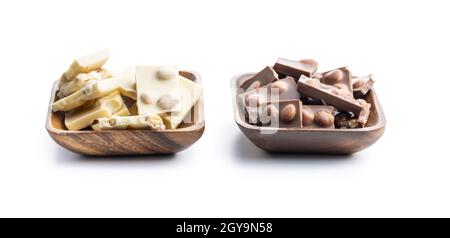 White and dark nutty chocolate with hazelnuts in bowl isolated on white background. Stock Photo