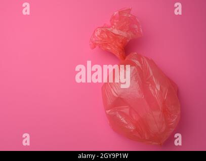 empty plastic trash bag on pink background, top view Stock Photo