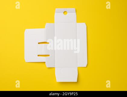 protective paper from under a box with a perfume, template from white corrugated cardboard, yellow background Stock Photo