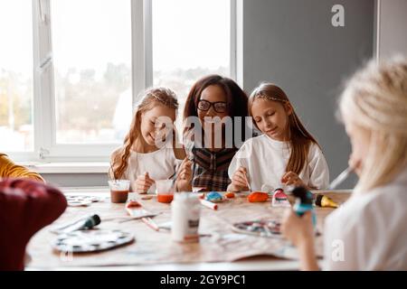 Smiling kids making art painting using water colors Stock Photo