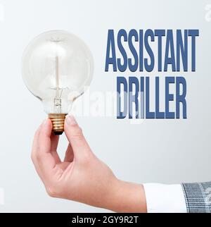 Writing displaying text Assistant Driller, Business concept to aid and assist the driller during rig operations Hand holding lamp showing or presentin Stock Photo