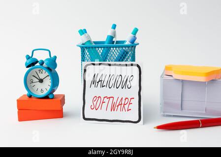 Hand writing sign Malicious Software, Business showcase the software that brings harm to a computer system Tidy Workspace Setup Writing Desk Tools And Stock Photo