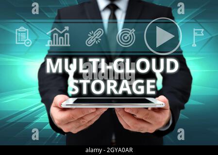 Writing displaying text Multi Cloud Storage, Concept meaning use of multiple cloud computing and storage services Man In Office Uniform Holding Tablet Stock Photo