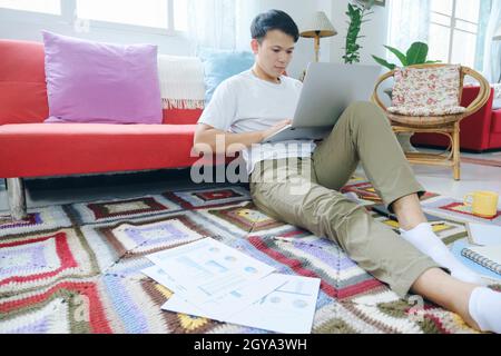 Young man online working and learning from home. Stock Photo