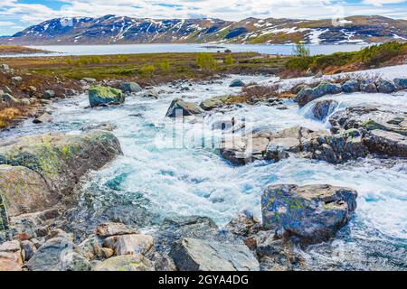 Beautiful Storebottane river by the vavatn lake with snow in the summer landscape in Hemsedal Norway. Stock Photo