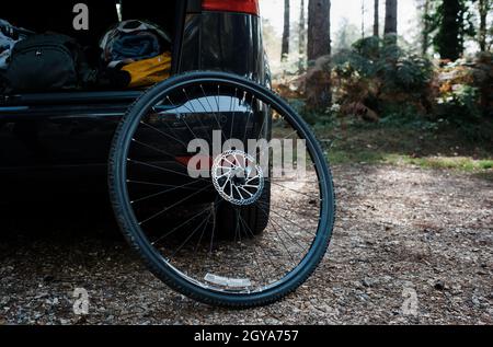 bike wheel against a car in the forest Stock Photo