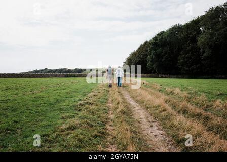 older couple walking together in the countryside Stock Photo
