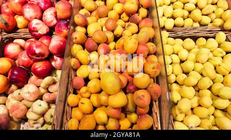 many fruit crates for sale in the fruit market. Apricot and peach in a shop window. Stock Photo