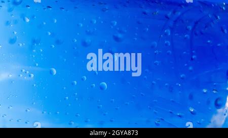 A lot of drops of water inside a plastic bottle. Blue background with water drops. Stock Photo