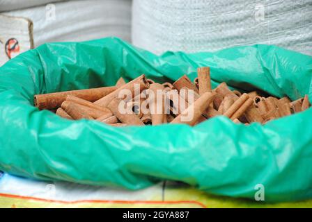 Dried bark strips of Cinnamon in a plastic sack at the spice market. This  spice obtained from the inner bark of several tree species from the genus C Stock Photo